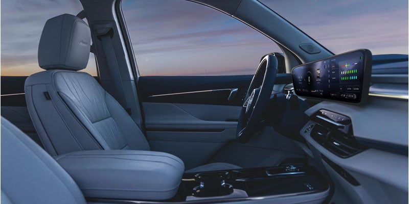 Buick Enclave Sport Touring interior seating and exterior rear styling detail images.