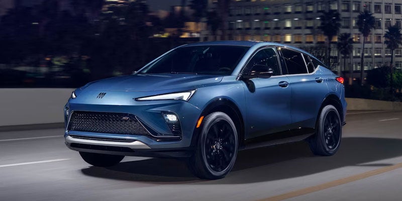 2026 Buick Envista compact SUV driving on a city street at night