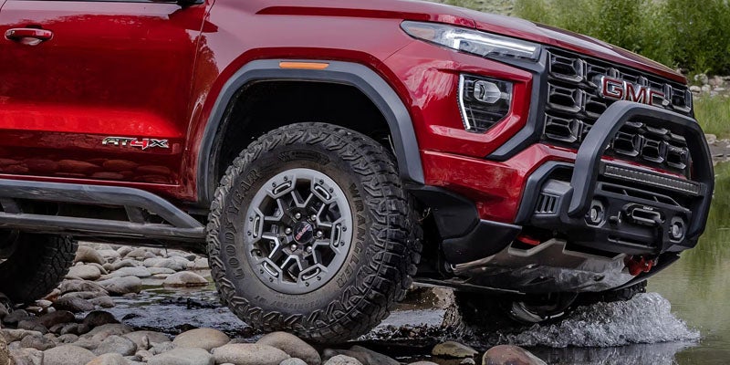 Front side view of the 2026 GMC Canyon showcasing bold grille and off-road capability