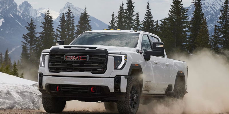2026 GMC Sierra 2500 HD driving through challenging terrain showcasing off-road strength