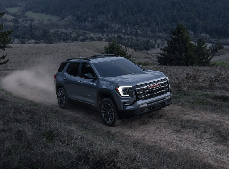 2027 GMC Terrain AWD driving on a rugged dirt trail demonstrating all-wheel-drive capability