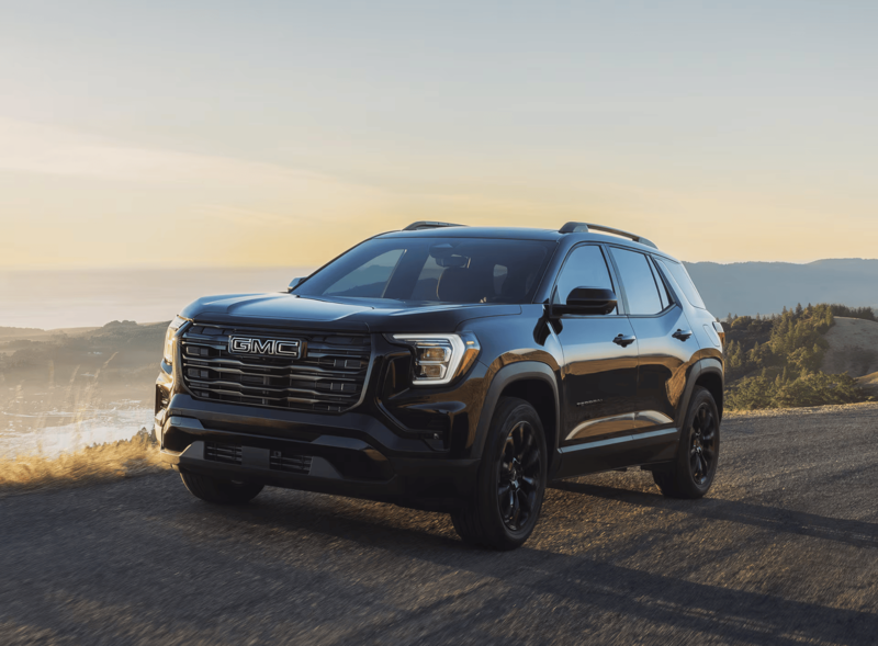 2027 GMC Terrain AWD driving on a scenic highway with advanced safety features