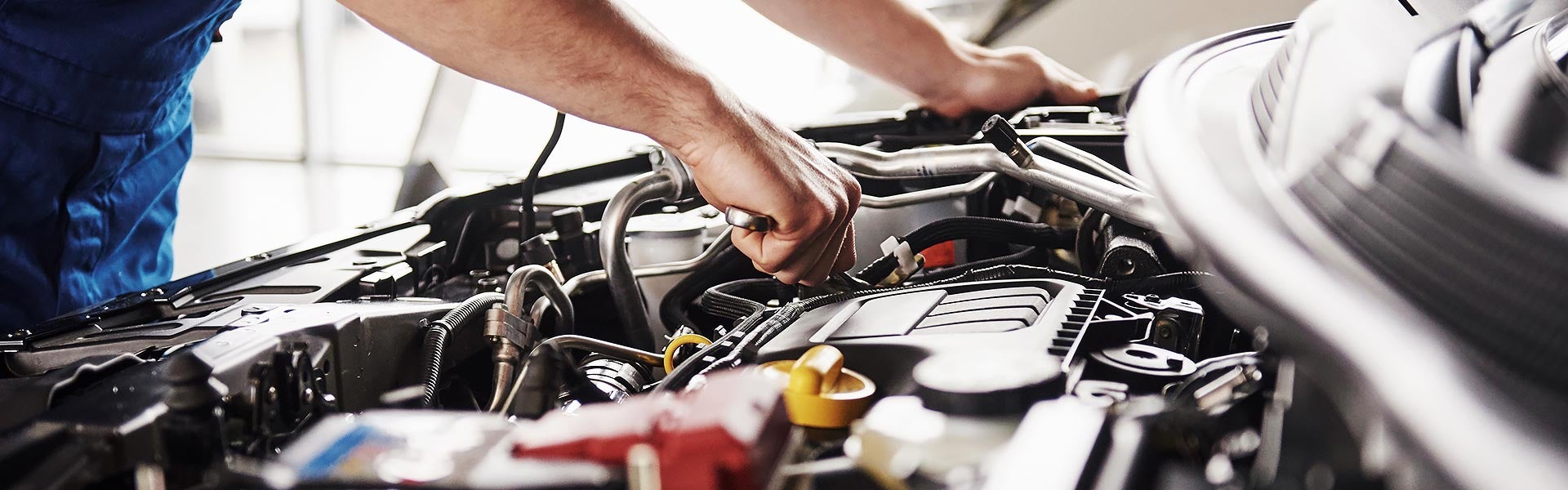 Automotive engine components during professional vehicle maintenance and repair service.